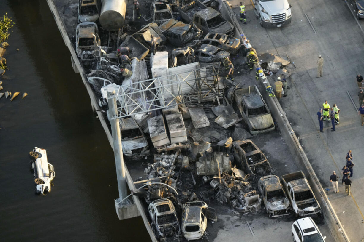 FILE - In this aerial photo, responders are seen near wreckage in the aftermath of a multi-vehicle pileup on Interstate 55 in Manchac, La., Monday, Oct. 23, 2023. The death toll from last week&rsquo;s series of highway crashes blamed on a &ldquo;super fog&rdquo; of smoke from marsh fires and morning fog has been lowered from eight to seven, Louisiana State Police said Friday, Oct. 27.