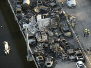 FILE - In this aerial photo, responders are seen near wreckage in the aftermath of a multi-vehicle pileup on Interstate 55 in Manchac, La., Monday, Oct. 23, 2023. The death toll from last week&rsquo;s series of highway crashes blamed on a &ldquo;super fog&rdquo; of smoke from marsh fires and morning fog has been lowered from eight to seven, Louisiana State Police said Friday, Oct. 27.