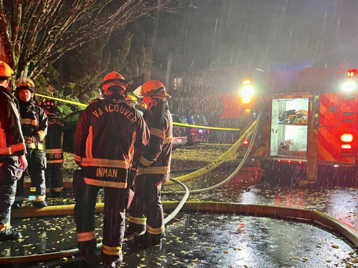 Vancouver firefighters await reassignment after knocking down a fire at the Nobl Park Apartments in Orchards on Saturday night.