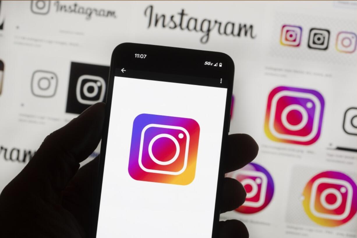 File - The Instagram logo is seen on a cell phone in Boston, USA, Oct. 14, 2022. The owner of Facebook and Instagram says it'll put labels on political ads created using artificial intelligence. The new policy announced Wednesday by Meta goes into effect Jan. 1 and will apply worldwide.