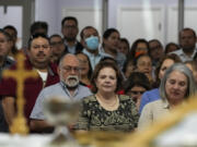 Parishioners attend Mass at St. Agatha catholic church, which has become the spiritual home of the growing Nicaraguan diaspora, Sunday, Nov. 5, 2023, in Miami. For the auxiliary bishop of Managua, one of his concelebrant priests and many in the pews who have had to flee or were exiled from Nicaragua recently, the Sunday afternoon Mass at the Miami parish is not only a way to find solace in community, but also to keep pushing back against the Ortega regime&rsquo;s violent suppression of all critics, including many Catholic leaders.