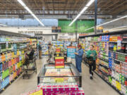 Shoppers browse the shelves at the grand opening of the downtown Vancouver New Seasons. Clark County employers added 1,200 jobs in October, with the latest labor report showing year-over-year growth in virtually every sector of the economy.