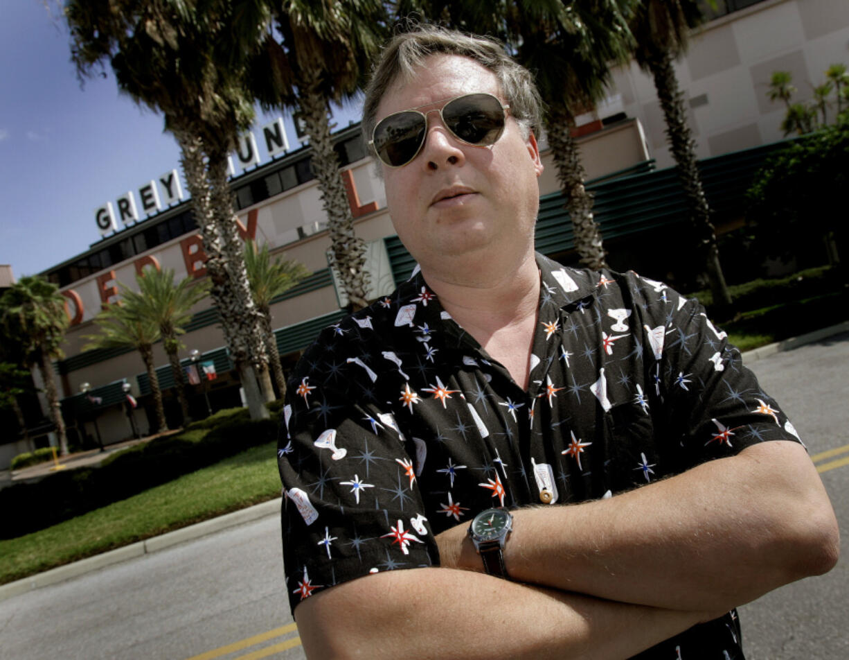 Author Tim Dorsey poses Sept. 5, 2007, at the Derby Lane Greyhound Track in St. Petersburg, Fla. Dorsey, who over his career published 26 novels, died Sunday.