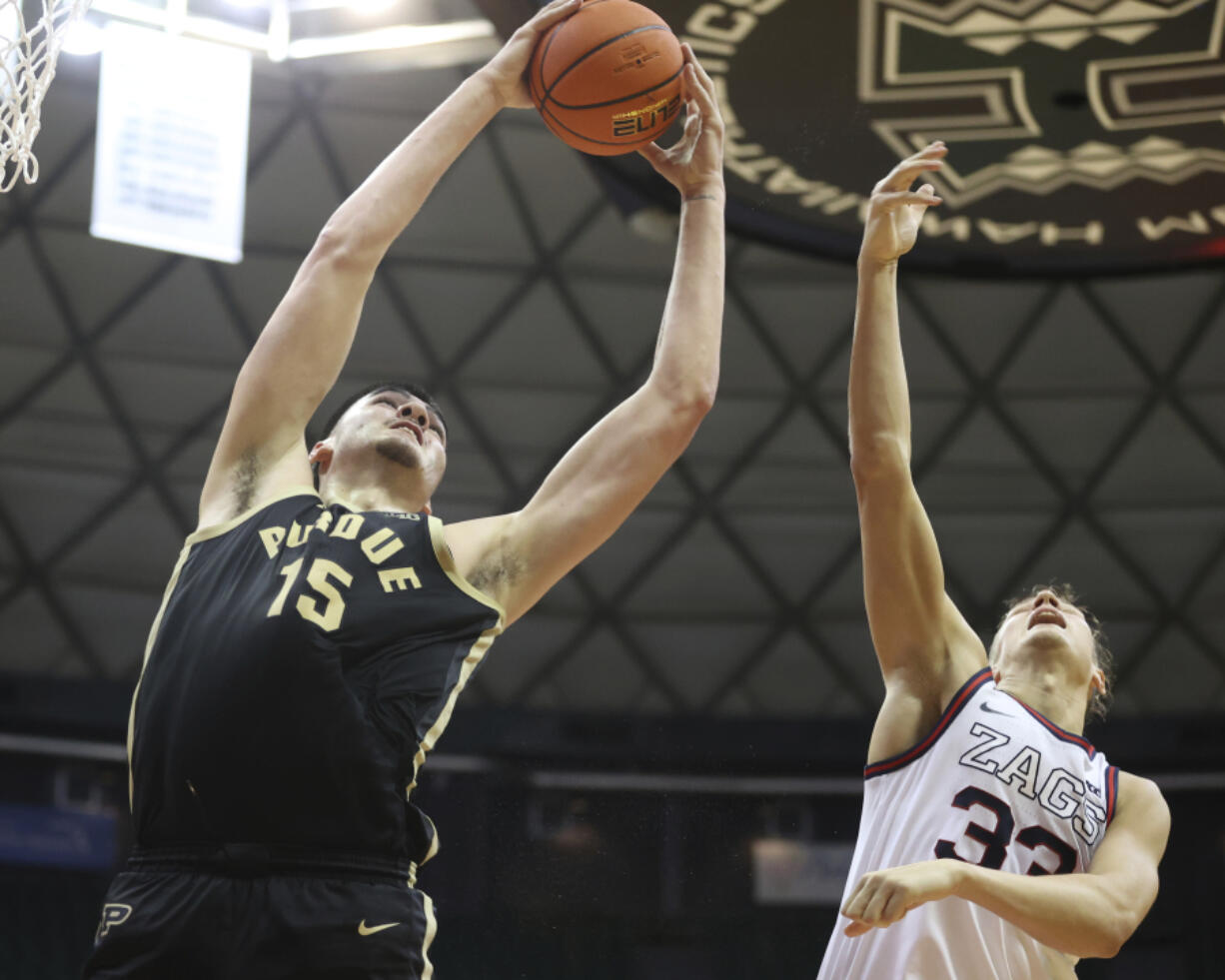 Purdue center Zach Edey (15) grabs a rebound over Gonzaga forward Ben Gregg during the second half of an NCAA college basketball game, Monday, Nov. 20, 2023, in Honolulu.