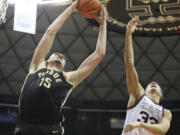 Purdue center Zach Edey (15) grabs a rebound over Gonzaga forward Ben Gregg during the second half of an NCAA college basketball game, Monday, Nov. 20, 2023, in Honolulu.