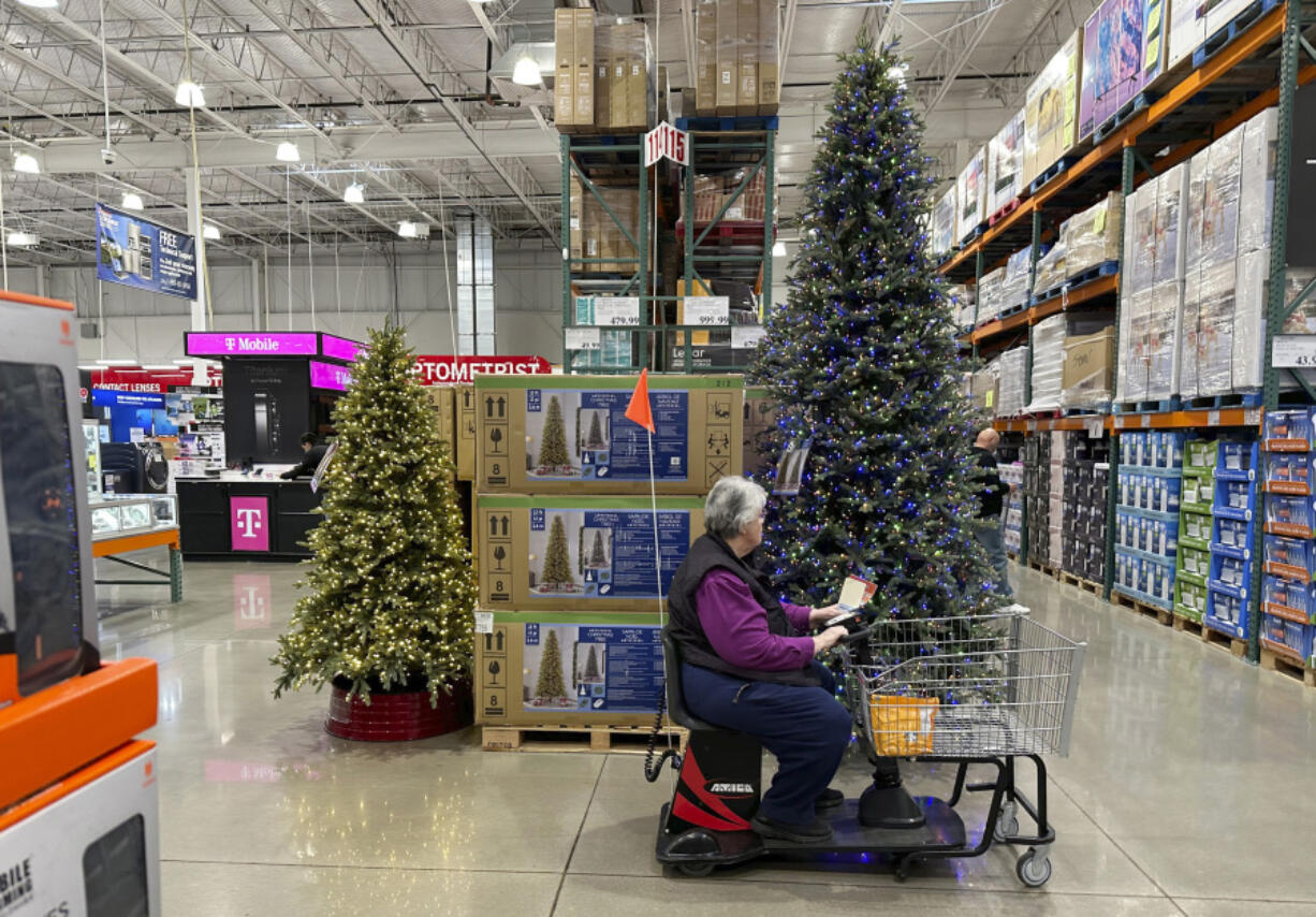 A shopper passes by a display of Christmas trees in a Costco warehouse Thursday, Oct. 26, 2023, in Sherian, Colo. On Wednesday, the Commerce Department releases U.S. retail sales data for October.