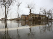 The Evpatoria - Saki highway is covered with water after a storm in Crimea, Monday, Nov. 27, 2023. A storm in the Black Sea took down power grids and left almost half a million people without power after it flooded roads, ripped up trees and damaged buildings in Crimea, Russian state news agency Tass said.