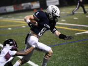 Skyview’s Gavin Packer (8) slips through the tackle of Bethel’s Jordan Williams (left) on his way to scoring a 36-yard touchdown pass play in the Storm’s 49-21 win over Bethel at Kiggins Bowl on Friday, Nov. 3, 2023.