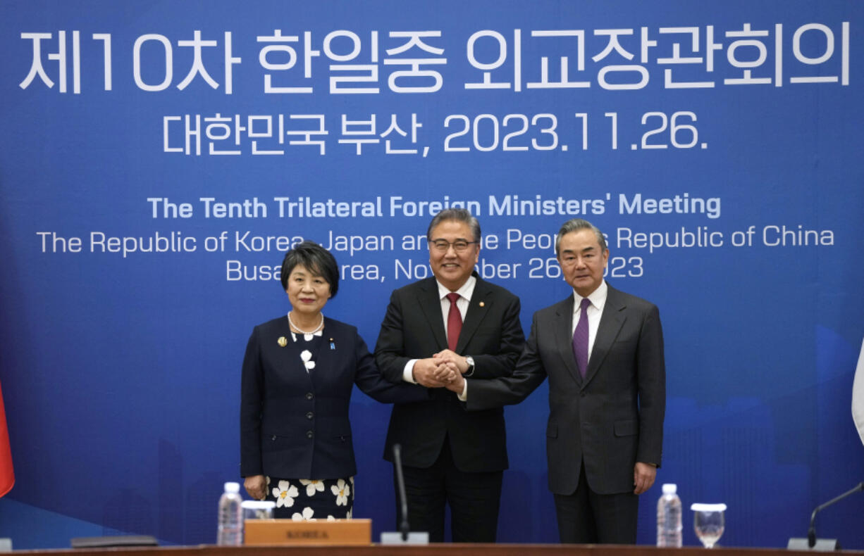 Chinese Foreign Minister Wang Yi, right, South Korean Foreign Minister Park Jin, center, and Japanese Foreign Minister Yoko Kamikawa pose for a photo prior to the trilateral foreign ministers&#039; meeting in Busan, South Korea, Sunday, Nov. 26, 2023.