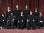 FILE - Members of the Supreme Court sit for a new group portrait following the addition of Associate Justice Ketanji Brown Jackson, at the Supreme Court building in Washington, Oct. 7, 2022. Bottom row, from left, Justice Sonia Sotomayor, Justice Clarence Thomas, Chief Justice John Roberts, Justice Samuel Alito, and Justice Elena Kagan. Top row, from left, Justice Amy Coney Barrett, Justice Neil Gorsuch, Justice Brett Kavanaugh, and Justice Ketanji Brown Jackson. The Supreme Court is adopting its first code of ethics, in the face of sustained criticism over undisclosed trips and gifts from wealthy benefactors to some justices. The policy was issued by the court Monday.  (AP Photo/J.