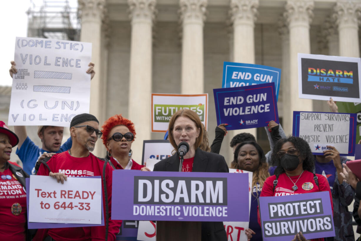 Actor Julianne Moore speaks during a rally at the Supreme Court on Tuesday, Nov. 7, 2023, in Washington. The Supreme Court is taking up a challenge to a federal law that prohibits people from having guns if they are under a court order to stay away from their spouse, partner or other family members.