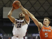 Gonzaga forward Anton Watson (22) goes to the net over Syracuse guard Justin Taylor (5) during the first half of an NCAA college basketball game, Tuesday, Nov. 21, 2023, in Honolulu.