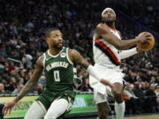 Portland Trail Blazers&#039; Jerami Grant drives to the basket against Milwaukee Bucks&#039; Damian Lillard during the first half of an NBA basketball game, Sunday, Nov. 26, 2023, in Milwaukee.