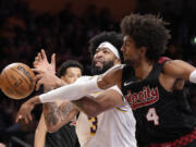 Portland Trail Blazers guard Matisse Thybulle, right, knocks the ball from the hands of Los Angeles Lakers forward Anthony Davis during the first half of an NBA basketball game Sunday, Nov. 12, 2023, in Los Angeles. (AP Photo/Mark J.