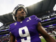 Washington quarterback Michael Penix Jr. smiles on the field following a 35-28 victory over Utah in an NCAA college football game Saturday, Nov. 11, 2023, in Seattle.