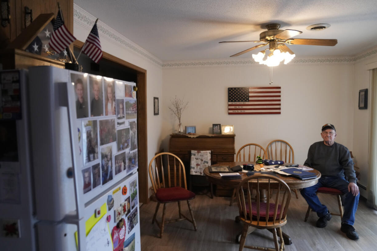 Earl Meyer, who fought for the U.S. Army in the Korean War, sits with war memorabilia at his home, Tuesday, Nov. 7, 2023, in St. Peter, Minn. Meyer, 96, is suing the Army to try to get the Purple Heart medal that he says he earned when he was wounded during fierce combat in June of 1951.