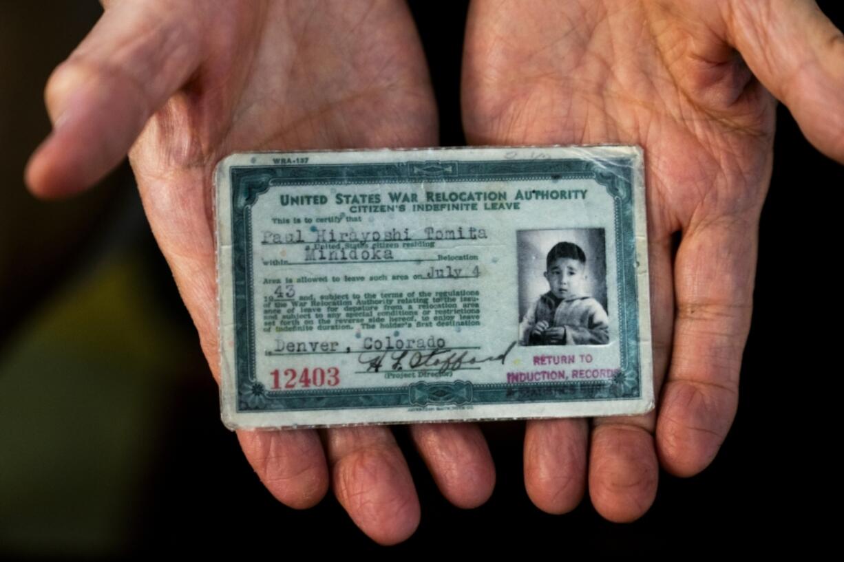 Paul Tomita displays a copy of his exit card granted to him on July 4, 1943, as the family was allowed to leave after Tomita&rsquo;s father signed loyalty documents and passed security clearance to work for the Office of Secret Service, which later became the CIA, Friday, July 7, 2023, in Twin Falls, Idaho.