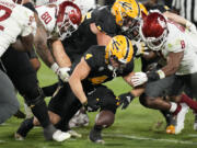 Arizona State running back Cameron Skattebo (4) fumbles the ball as Washington State defensive end Brennan Jackson (80) and linebacker Devin Richardson (8) close in during the second half of an NCAA college football game Saturday, Oct. 28, 2023, in Tempe, Ariz. Skattebo recovered the fumble. (AP Photo/Ross D.