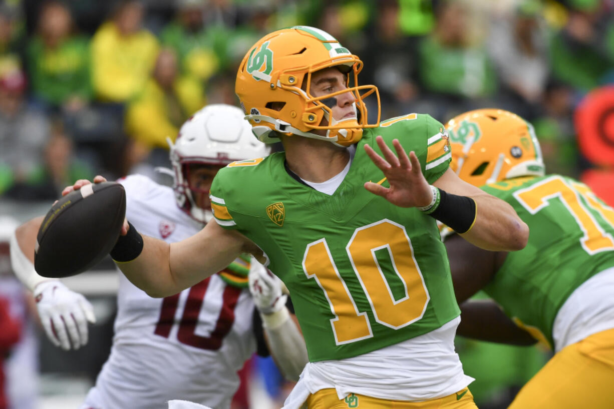 Oregon quarterback Bo Nix (10) looks to throw a pass against Washington State during the first half of an NCAA college football game Saturday, Oct. 21, 2023, in Eugene, Ore.