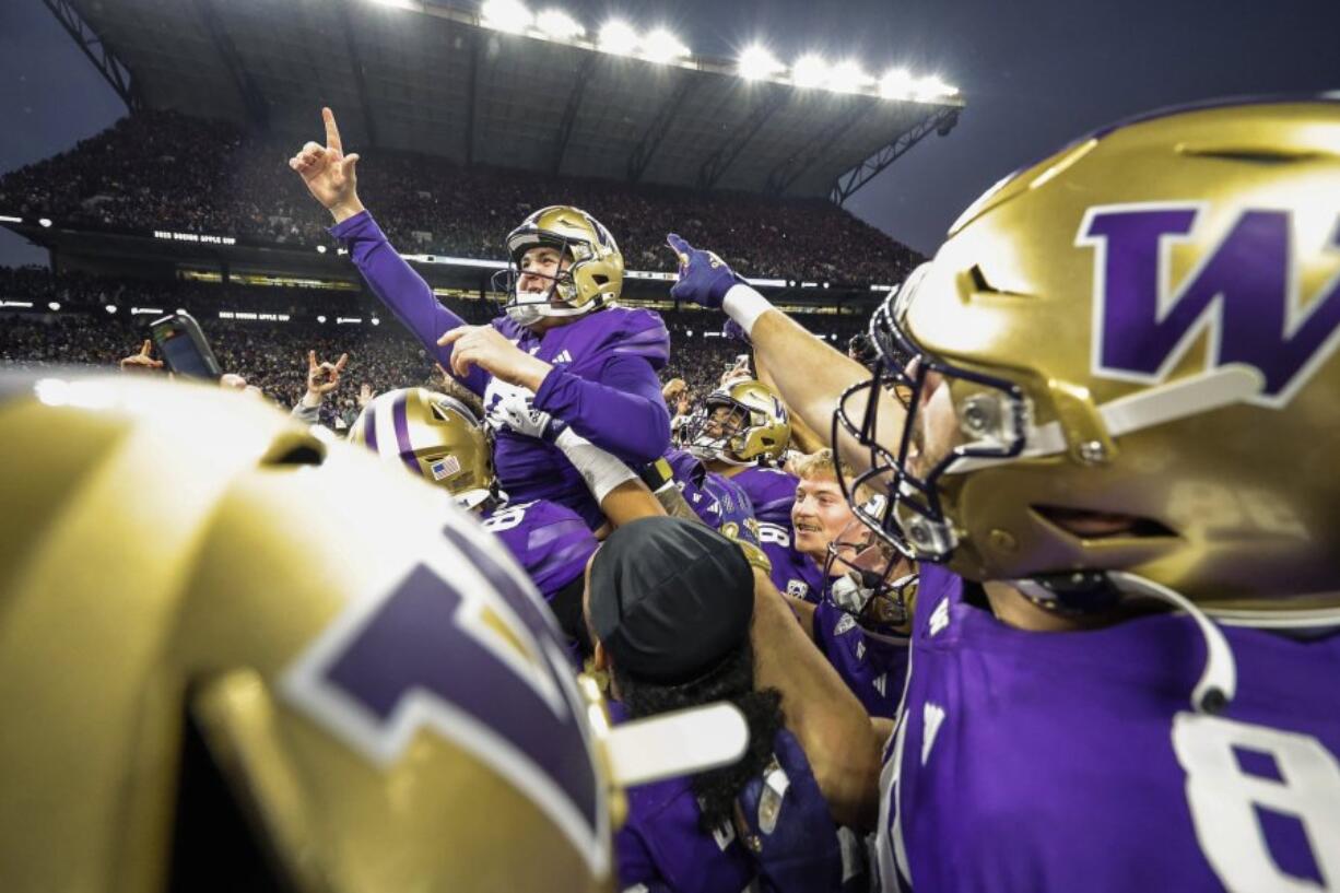 Washington&rsquo;s Grady Gross is carried off the field after kicking the winning field goal against Washington State during an NCAA college football game Saturday, Nov. 25, 2023, in Seattle.