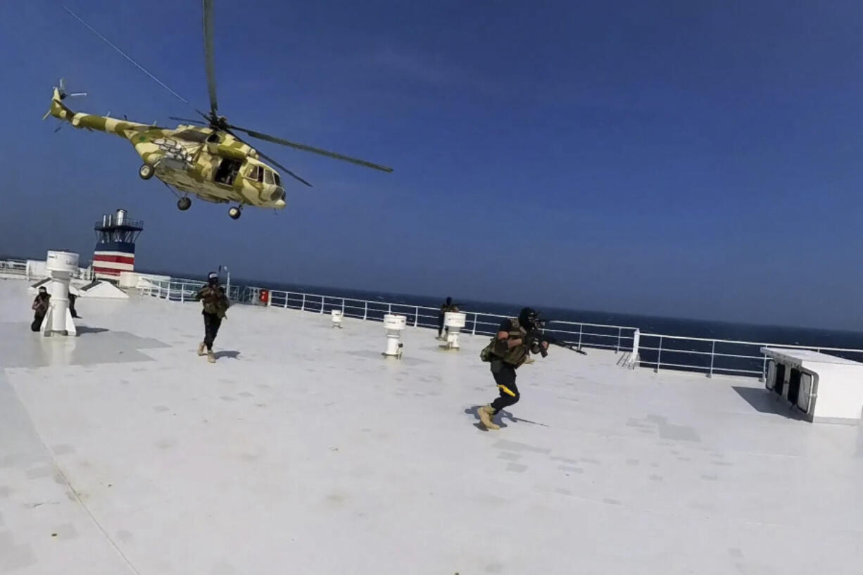 This photo released by the Houthi Media Center shows Houthi forces boarding the cargo ship Galaxy Leader on Sunday, Nov. 19, 2023. Yemen&rsquo;s Houthis have seized the ship in the Red Sea off the coast of Yemen after threatening to seize all vessels owned by Israeli companies.