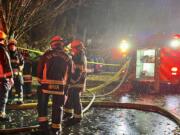 Vancouver firefighters await reassignment after knocking down a fire at the Nobl Park Apartments in Orchards on Saturday night.