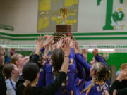 The Columbia River volleyball team hoists the championship trophy after beating Ridgefield for the 2A district title in Tumwater (Josh Kirshenbaum/Centralia Chronicle)