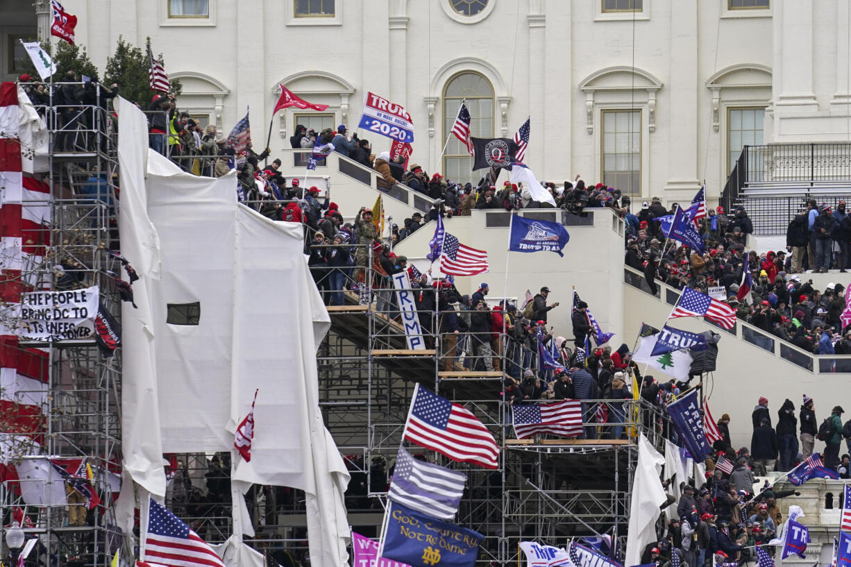 FILE - In this Jan. 6, 2021 file photo insurrectionists loyal to President Donald Trump riot outside the Capitol in Washington.