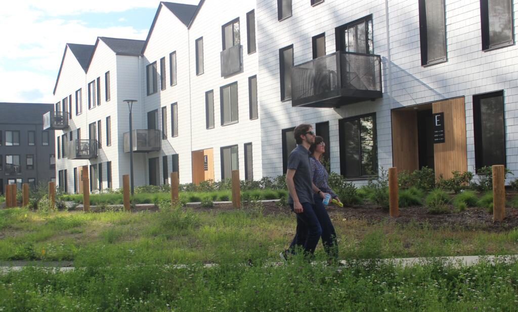 Adam Fractor and Chelsea Rooklyn, employees for Portland-based Killian Pacific walk through Eagle View Park between Ninebark apartments and the Columbia River in Washougal.