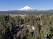 Mount Adams rises above Trout Lake in Klickitat County. The U.S. Geological Survey&rsquo;s Cascades Volcano Observatory is proposing to install five real-time monitoring stations around the volcano to detect lahars, which would give neighboring communities time to evacuate.