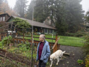 Valerie Alexander, owner of Coyote Ridge Ranch, walks through one of the gardens on her property while joined by family dog Kelo, 15, near La Center.