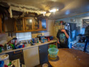 Casey Jewell, left, and her son, Charley Jewell, live in a mobile home with a large hole in the kitchen ceiling. Cassie Jewell said the hole formed last spring and has since grown.