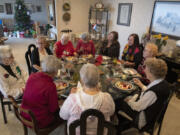 Rose Funk of Vancouver, left, hosts her former Girl Scouts troop, the Evergreen Pollyannas, for a holiday potluck on Dec. 6. The group has been meeting once a month for 75 years.