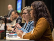 Sen. Annette Cleveland, D-Vancouver, foreground left, speaks to the crowd while Rep. Monica Stonier, D-Vancouver, right, listens during a 2024 legislative outlook at the Hilton Vancouver Washington on Friday.