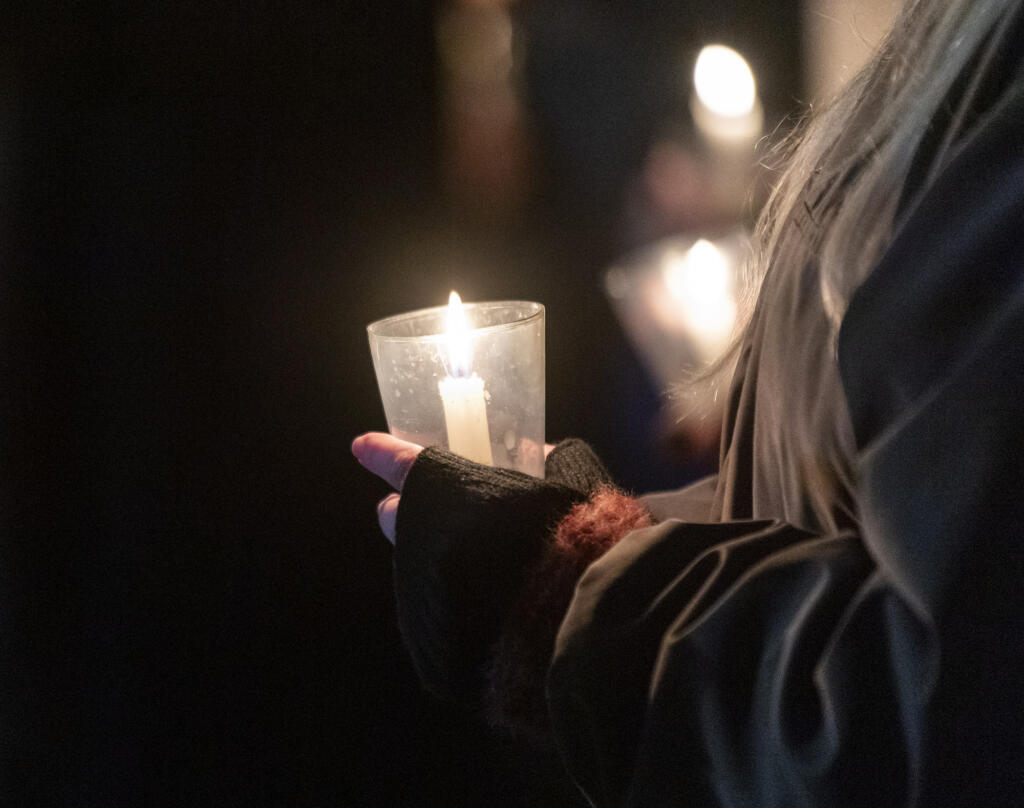 Attendees hold candles Friday, Dec. 21, 2023, during a Homeless Persons Memorial Day event at St. Paul Lutheran Church in downtown Vancouver.