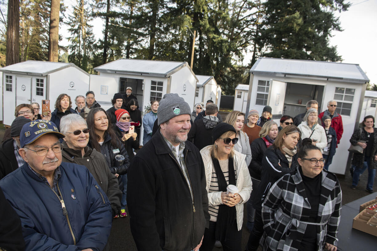 Members of the community gather Friday to listen to Gov. Jay Inslee speak as he visits the fourth Safe Stay community at 4611 Main St. in Vancouver. Inslee said the safe stays are lifesaving.