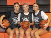 Washougal's Albaugh sisters — seniors Bella, from left, Ireland, and junior Lucy — sit for a portrait Wednesday, Dec. 13, 2023, at Washougal High School. The trio play pivotal roles for the Panthers' girls basketball team.