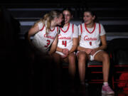 Camas senior Riley Sanz, from left, talks to junior Sophie Buzzard and senior Reagan Jamison during pregame introductions Friday, Dec. 15, 2023, before the Papermakers’ 58-46 win against Eastlake at Camas High School.