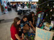 Hockinson senior Sophia Sermone, 18, middle, consolidates toy donations meant for Doernbecher Children&rsquo;s Hospital in Portland. Classmates Zachary Chung, right, and Sarah Deroos, left, both 17 and juniors, helped with donations.