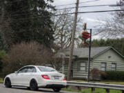 A motorist passes the sign for the former Sigrid&rsquo;s cafe, which operated for many years along Northeast 72nd Avenue north of Vancouver. The log cabin that housed the restaurant is now a private residence.