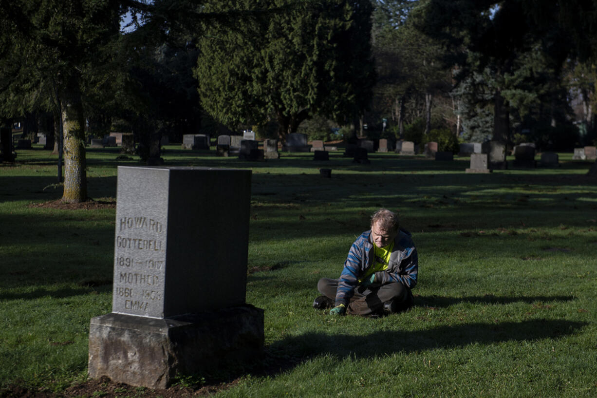 Come rain or shine, volunteer Martin Jacobsen comes to Park Hill Cemetery to clear weeds, grass and mud from headstones. Jacobsen is one of two volunteers who have been helping to keep Park Hill Cemetery&rsquo;s grounds neat and clean. At top, volunteer Ngoc Birrer keeps a grave in shape while working at Park Hill Cemetery on Dec. 21.