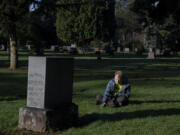 Come rain or shine, volunteer Martin Jacobsen comes to Park Hill Cemetery to clear weeds, grass and mud from headstones. Jacobsen is one of two volunteers who have been helping to keep Park Hill Cemetery&rsquo;s grounds neat and clean. At top, volunteer Ngoc Birrer keeps a grave in shape while working at Park Hill Cemetery on Dec. 21.