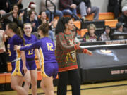 Columbia River coach Tuileisu Anderson greets her players as they come off the court at the end of the first half of River&rsquo;s 68-47 win over Washougal at Washougal High School on Thursday, Dec. 21, 2023.