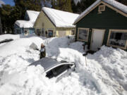 Kadyn Wheat shovels snow in early March as he works to free the family car, entombed after successive snowstorms in the San Bernardino Mountains.