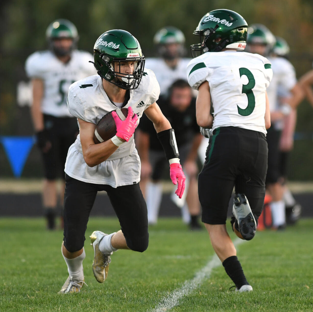 Woodland junior Elijah Andersen, left, runs with the ball on Sept. 7, 2023, during a game against La Center at La Center High School.