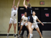 Hudson’s Bay’s Promise Bond (2) jumps to contest a shot attempt from Hockinson’s Siena Brown (5) during a 2A Greater St. Helens League girls basketball game on Friday, Dec. 8, 2023, at Hudson’s Bay High School.