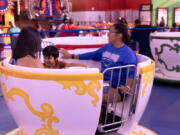 From left, Visitors from New Mexico Allyn H, Jaycub H and Amaya J, who opted to give their initials as last names, ride the new Twistin&Ccedil;&fnof;&Ugrave; Tea Cups in the Adventuredome at Circus Circus on Wednesday, July 19, 2023, in Las Vegas. The hotel-casino is in the process of an at least $30 million renovation.