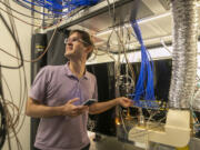 Marko Cetina, Duke assistant professor of Physics, works in the lab at the Duke Quantum Center on Aug. 30, 2022, in Durham, North Carolina. His research is focused on increasing complex quantum algorithms with increased numbers of quantum bits.