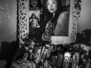 Jeramie Naya Vives Osorio&Ccedil;&fnof;&Ugrave;s mother gazes into a mirror above her altar. Her daughter died in March, just eight weeks shy of her 17th birthday.