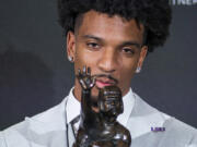 LSU quarterback Jayden Daniels kisses the Heisman Trophy during a news conference after winning the college football award, Saturday, Dec. 9, 2023, in New York.
